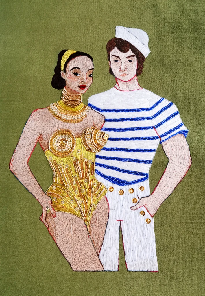 Jean Paul Gaultier modele wearing golden corset and mariniere